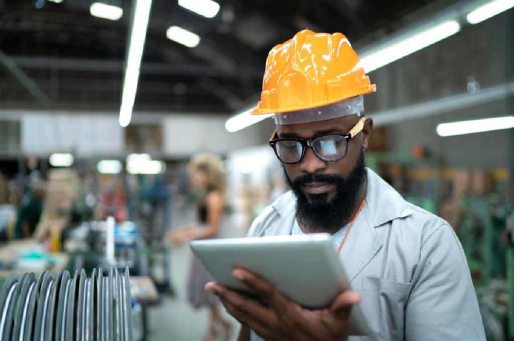 factory worker, staying focused at work, man holding a tablet