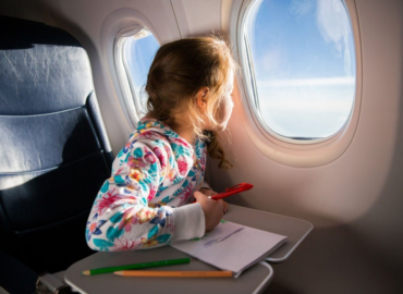 flight with kids, child coloring with crayons in airplane