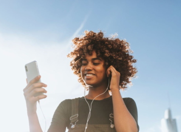 get paid to listen to music, girl listening to music on phone