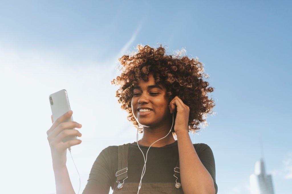 get paid to listen to music, girl listening to music on phone