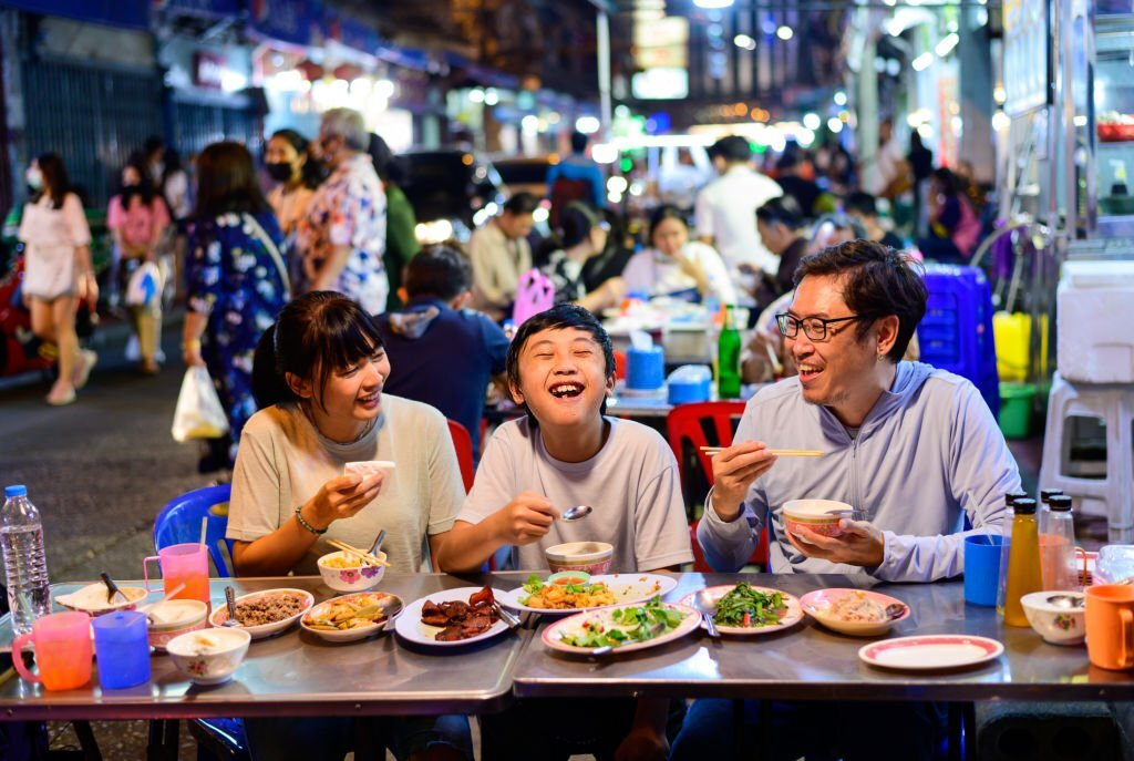 family enjoying food, street food