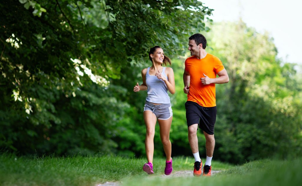 couple jogging in a park, workout routine