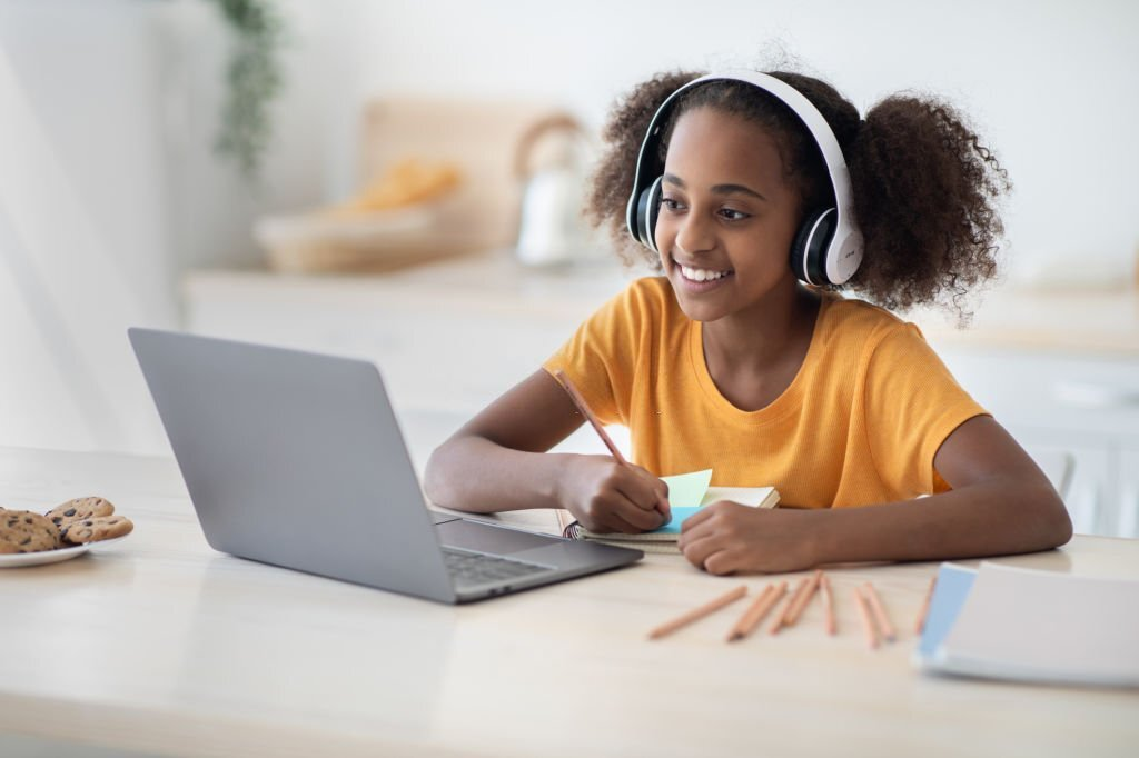 young black girl studying on a computer