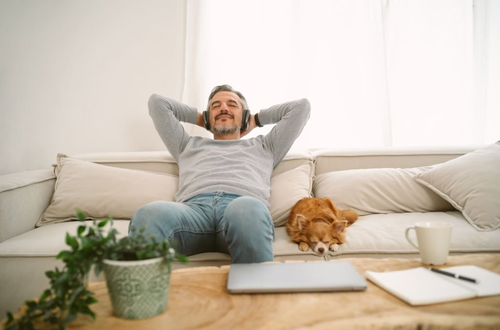 calm middle aged man relaxing on a sofa