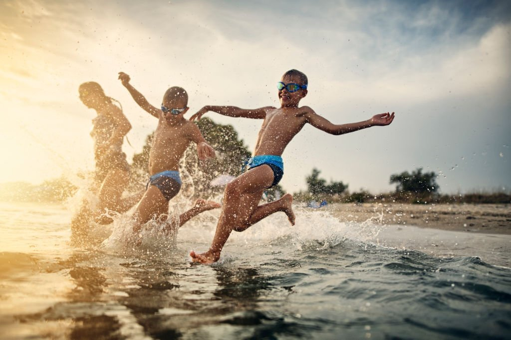 candid photo of young kids playing in water, travel photography