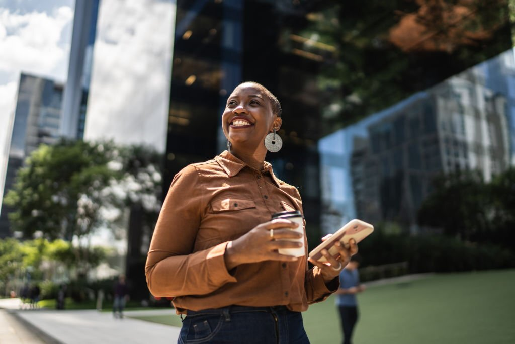 self-confidence, business woman holding coffee and smartphone