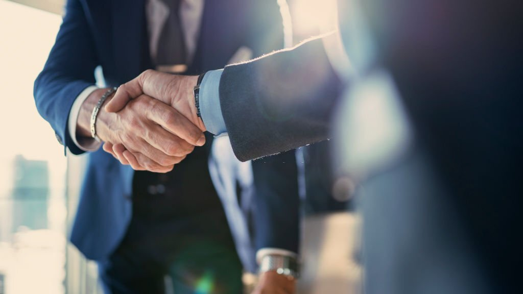 business people shaking hands, business partnership meeting in an office