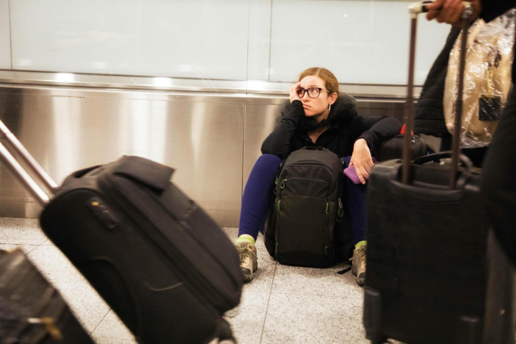 flight delay, woman waiting for her flight at airport